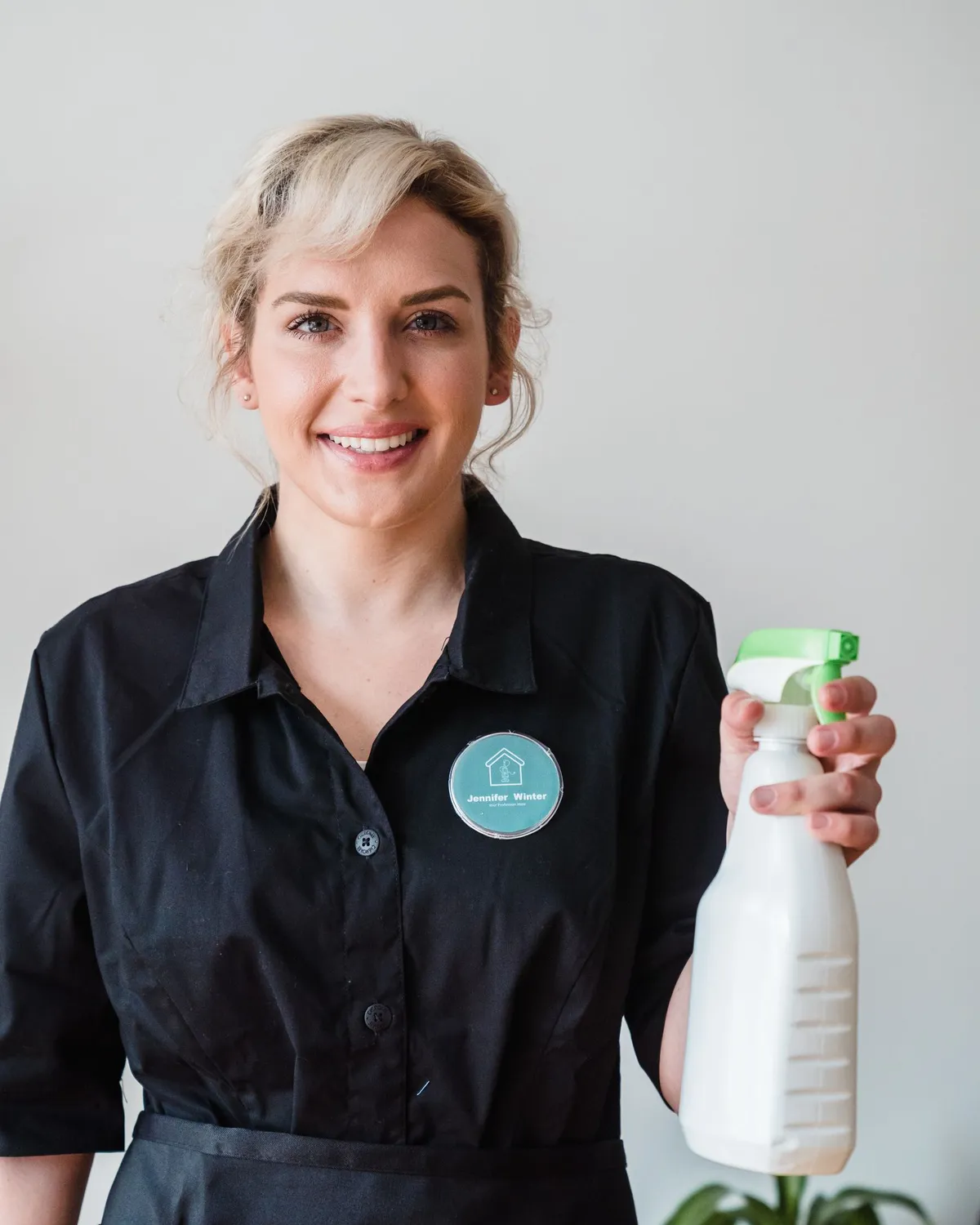 Professional cleaner wiping a bright kitchen counter